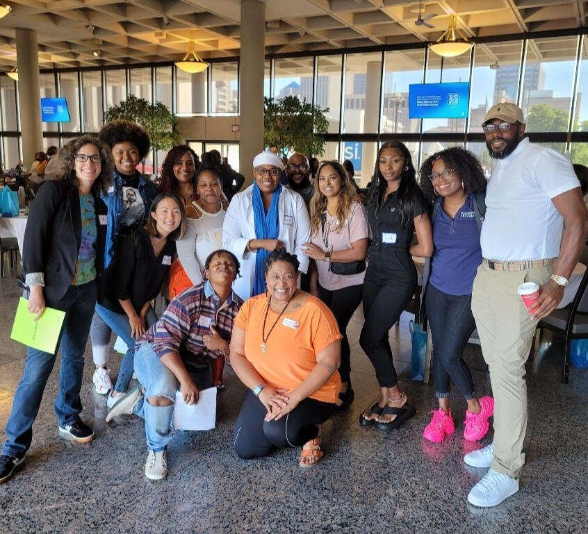 Large group from Signature Educational Solutions posed together and smiling