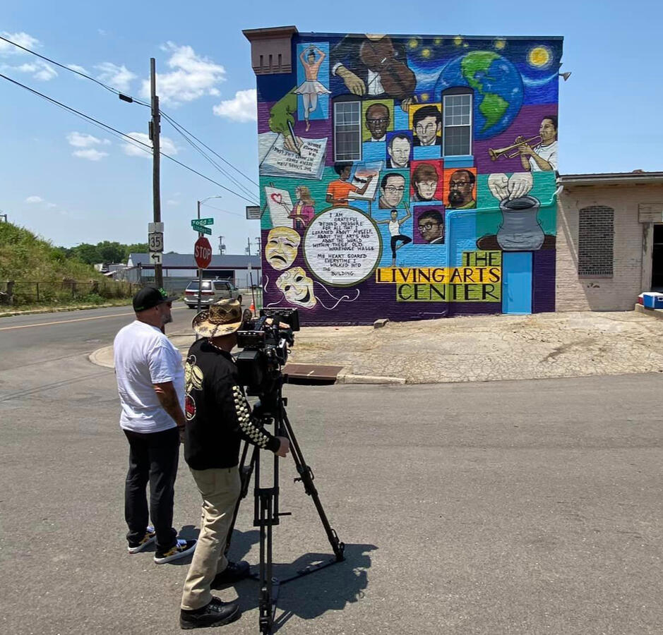 Crew filming The Living Arts Center completed mural