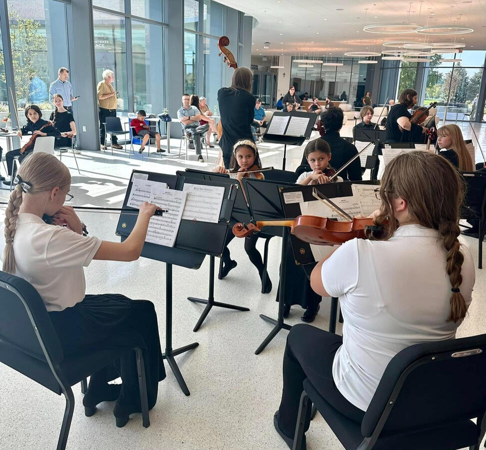 Miami Valley Symphony Orchestra Youth Strings performing in sunlit room