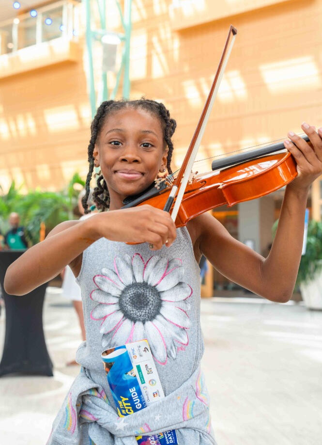 DPAA/Kirsten Pribula Young African-American girl playing the violin in the Schuster Center
